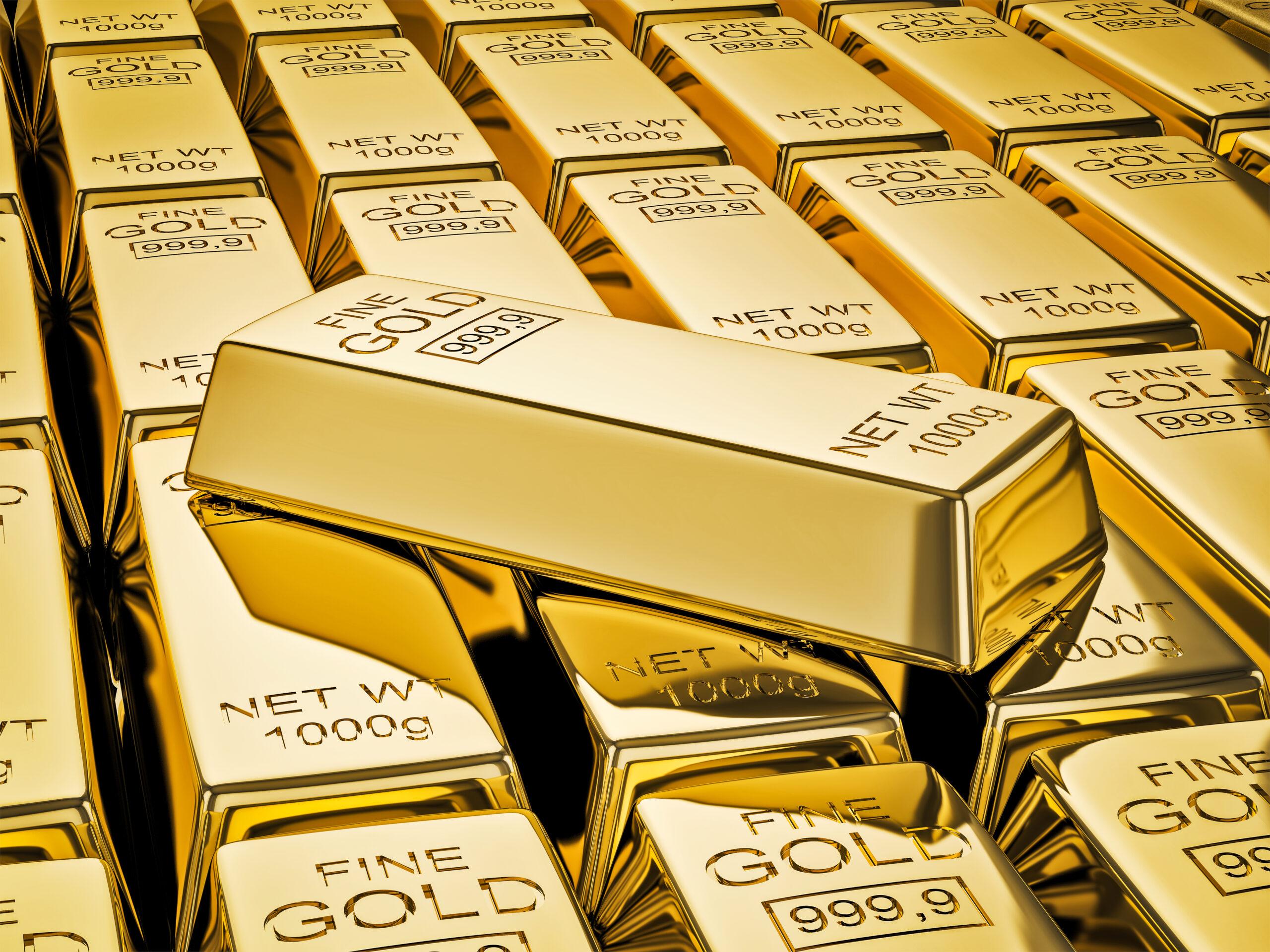 gold bar on stacks of gold bullions close up