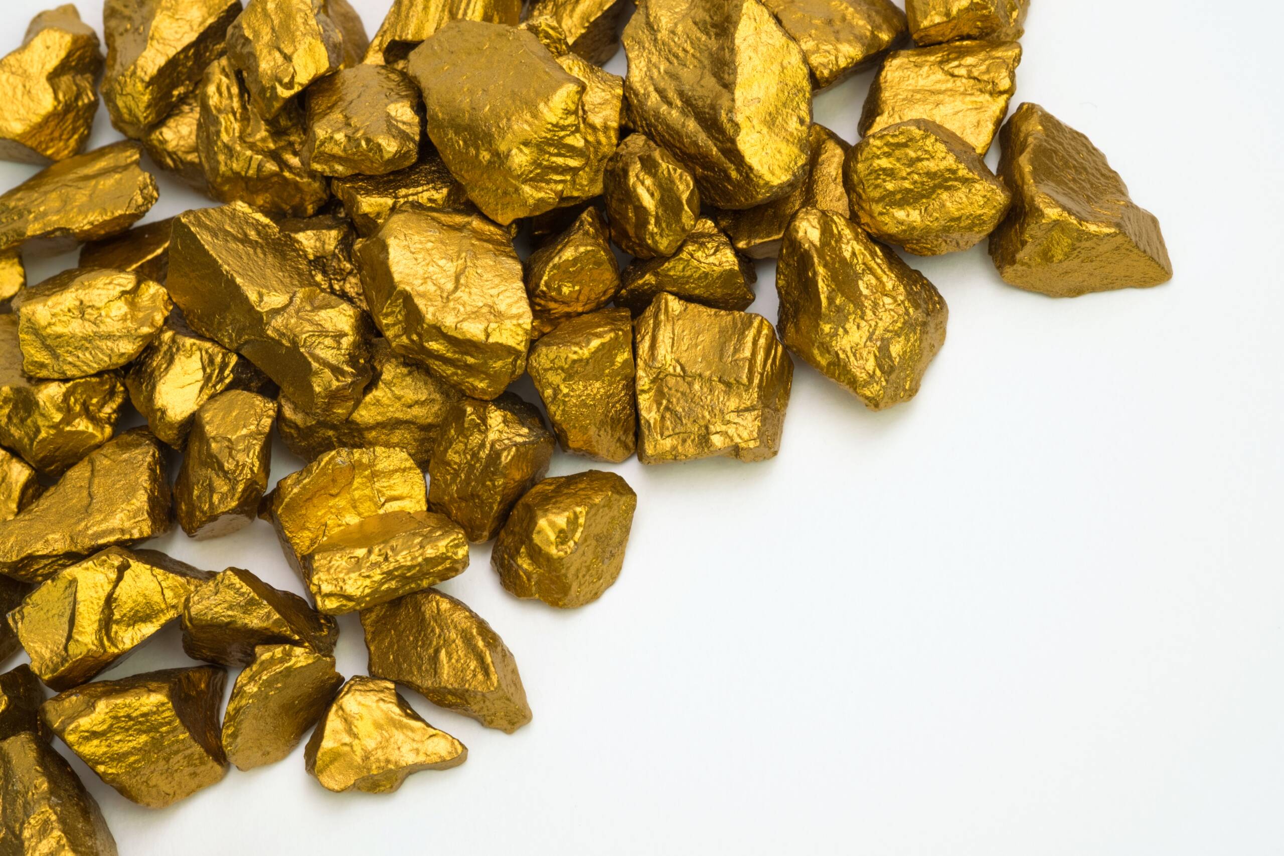 a pile of gold nuggets or gold ore isolated on white background,